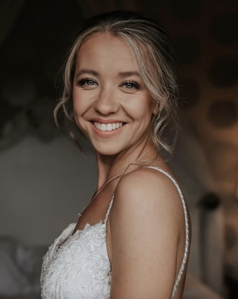 Bride looking over her shoulder in a lace gown