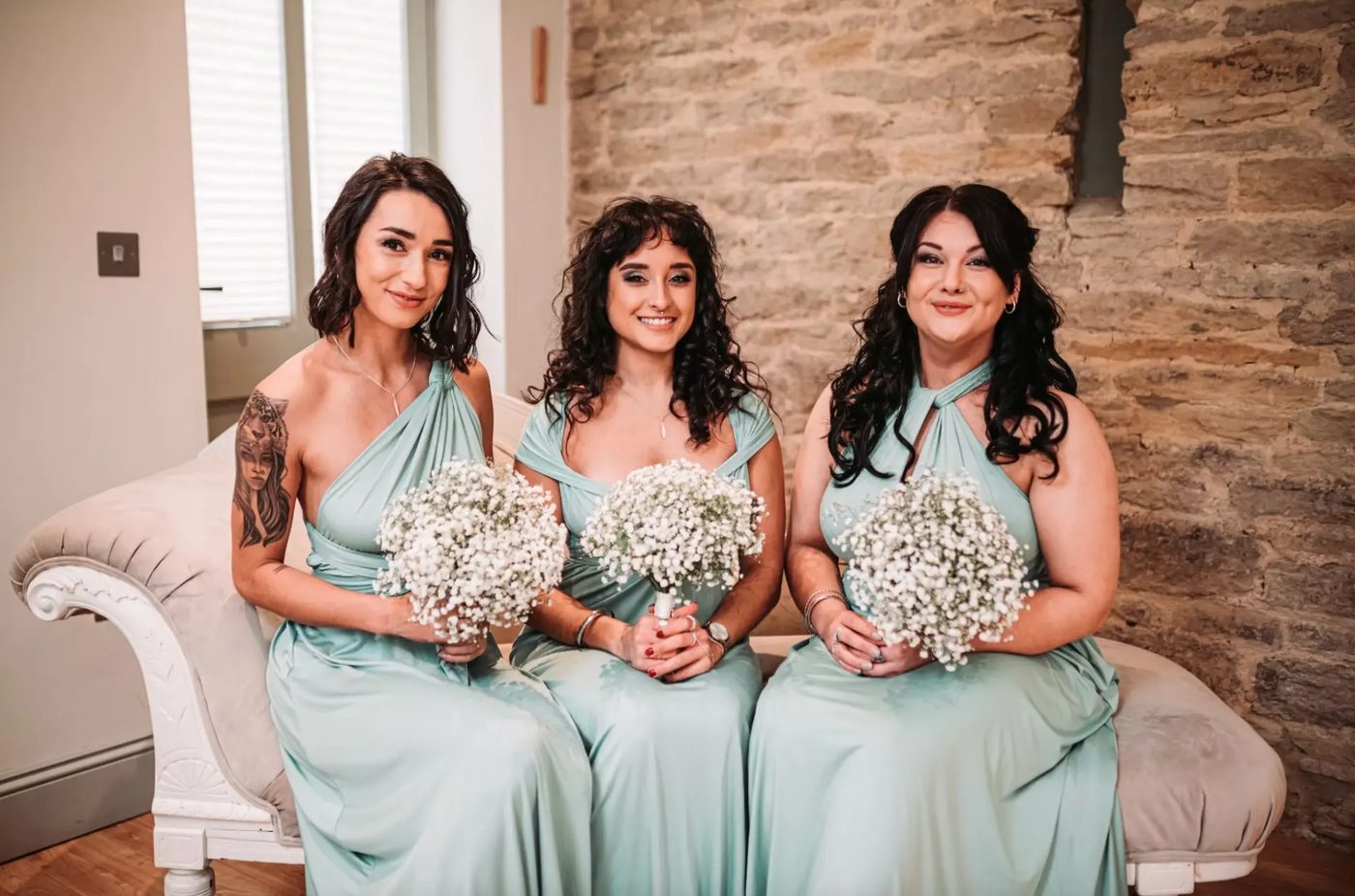 Bridesmaids holding baby's breath bouquets